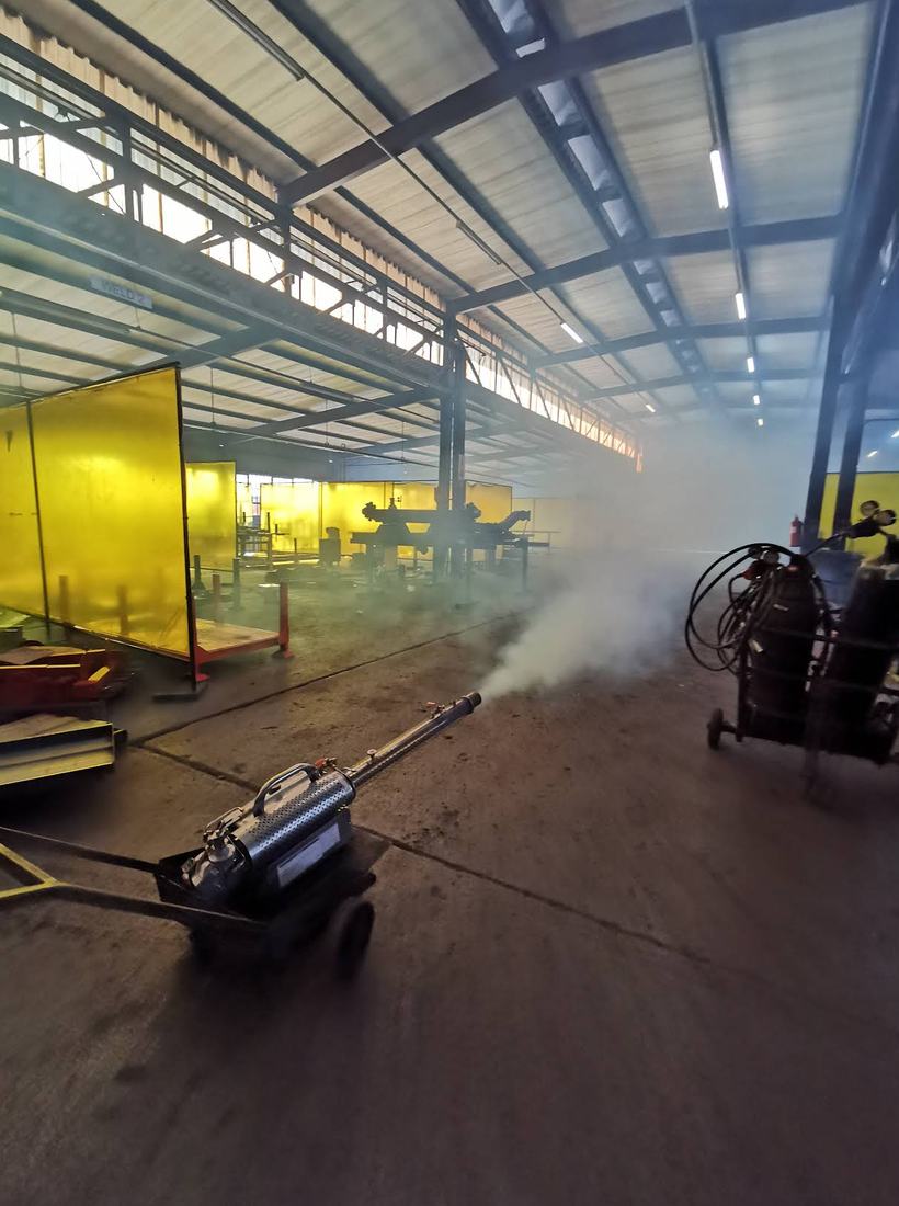 Fogging machine treating a welding and fabrication bay